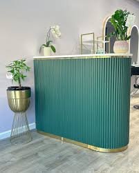 Green reception desk with fresh plants